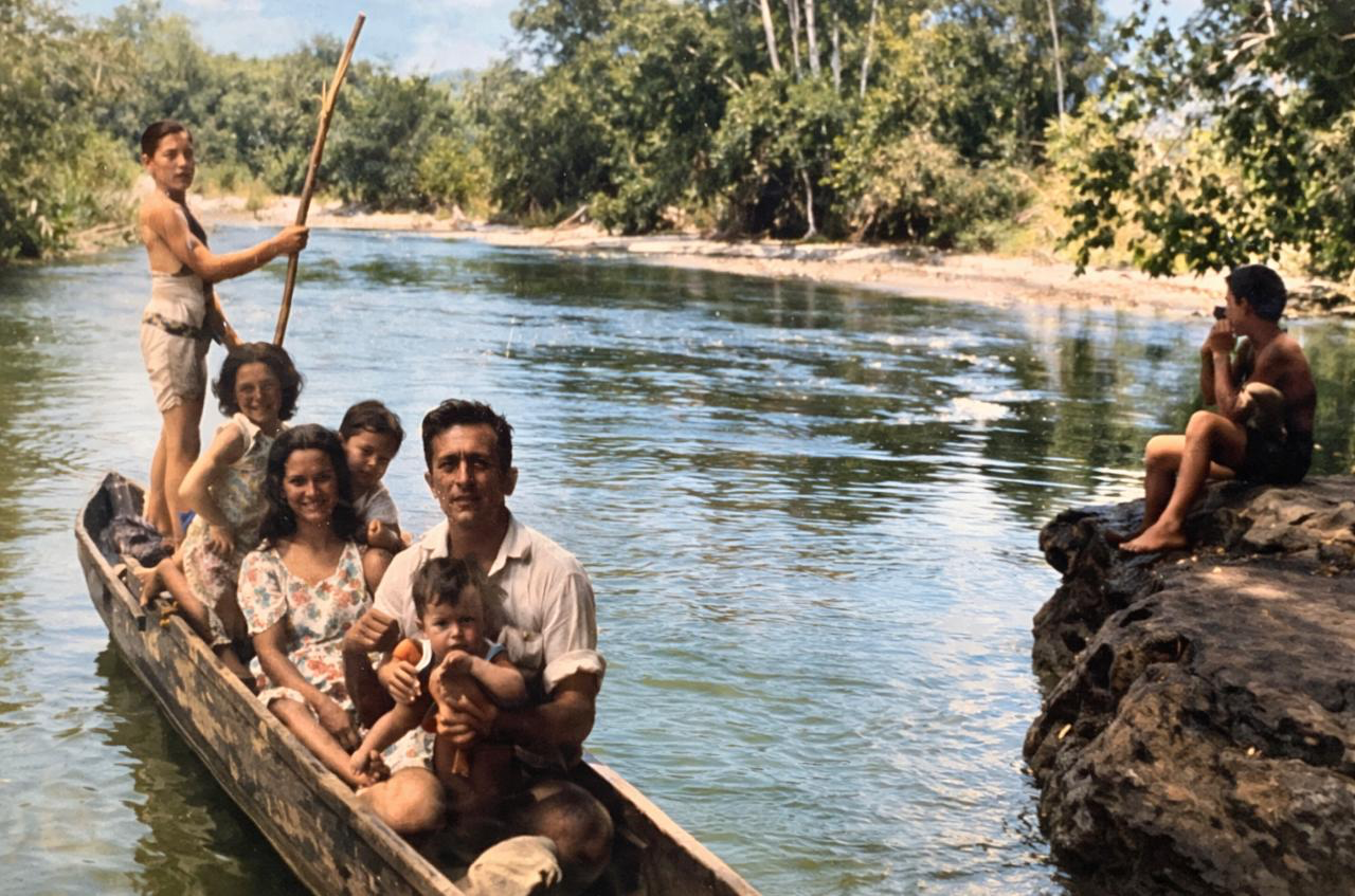 Fotografía del archivo familiar que inspiró CANOA: una familia en una canoa sobre el río.